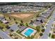 Aerial view features community amenities, including a pool, playground, and green spaces at 144 Williamson Dr, Davenport, FL 33897