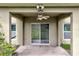 Back porch with ceiling fan, featuring sliding glass doors that overlook a large yard at 144 Williamson Dr, Davenport, FL 33897