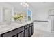 Bathroom featuring a double sink vanity and a tub with shower, illuminated by natural light at 144 Williamson Dr, Davenport, FL 33897