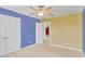 Bedroom with carpet, ceiling fan, closet, and two-tone paint scheme at 144 Williamson Dr, Davenport, FL 33897