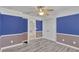 Bedroom with plank flooring, ceiling fan, closet, and two-tone paint scheme at 144 Williamson Dr, Davenport, FL 33897