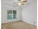 A bright bedroom is filled with natural light from a large window and features a ceiling fan at 144 Williamson Dr, Davenport, FL 33897