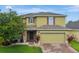 Charming two-story home with manicured lawn and a two-car garage at 144 Williamson Dr, Davenport, FL 33897