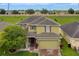 Two story house with a two-car garage, well-manicured lawn, and beautiful landscaping at 144 Williamson Dr, Davenport, FL 33897
