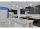 Stylish kitchen with granite countertops, stainless steel appliances, and island sink at 144 Williamson Dr, Davenport, FL 33897