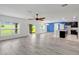 Open concept living room flows into a kitchen and dining area at 144 Williamson Dr, Davenport, FL 33897