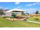 Community playground with modern equipment and a picnic table, perfect for outdoor fun at 144 Williamson Dr, Davenport, FL 33897