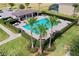 Aerial view of a community pool with lush landscaping and ample seating at 144 Williamson Dr, Davenport, FL 33897