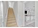 Carpeted staircase connects the home's levels with neutral tones at 144 Williamson Dr, Davenport, FL 33897