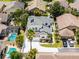 Aerial view of a home with pool, and lush landscaping in a residential neighborhood at 14423 Tambourine Dr, Orlando, FL 32837