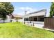 Spacious backyard featuring a well-maintained lawn, solar panels, and a screened patio for outdoor enjoyment at 14423 Tambourine Dr, Orlando, FL 32837