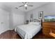 Bedroom featuring a ceiling fan, a bed, wood floors, and a window at 14423 Tambourine Dr, Orlando, FL 32837