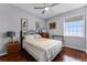 Bedroom with a ceiling fan, a bed, wood floors, and a window at 14423 Tambourine Dr, Orlando, FL 32837