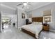 Light-filled bedroom features stylish flooring and a classic design with a staircase leading to the living area at 14423 Tambourine Dr, Orlando, FL 32837