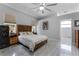 Bright bedroom with stylish floors, a ceiling fan, and ensuite bathroom access at 14423 Tambourine Dr, Orlando, FL 32837