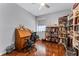 Home office with wood floors, a ceiling fan, and a large window at 14423 Tambourine Dr, Orlando, FL 32837