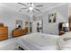Bedroom showcasing neutral walls, wood dressers, and a bright atmosphere for relaxation and comfort at 14423 Tambourine Dr, Orlando, FL 32837