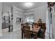 Dining room with wood table, seating for six, and an open view to the kitchen and breakfast nook at 14423 Tambourine Dr, Orlando, FL 32837
