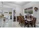 Bright dining room features wood table, seating for six, and sliding glass doors to an outdoor space at 14423 Tambourine Dr, Orlando, FL 32837