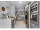Well-equipped kitchen with stainless steel appliances, gray cabinets, and granite countertops at 14423 Tambourine Dr, Orlando, FL 32837