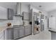 Modern kitchen featuring gray cabinets, stainless steel appliances, and granite countertops at 14423 Tambourine Dr, Orlando, FL 32837