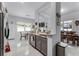 Open concept kitchen with stainless steel appliances, granite countertops, and views to the dining area at 14423 Tambourine Dr, Orlando, FL 32837