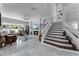Open living room with staircase, ceiling fan, tile flooring, large windows, fireplace, and comfortable seating at 14423 Tambourine Dr, Orlando, FL 32837