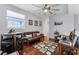 Living room with light walls, dark wood floors and a large fan at 14423 Tambourine Dr, Orlando, FL 32837