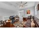 Sitting area with light walls, dark wood floors and a large fan at 14423 Tambourine Dr, Orlando, FL 32837
