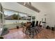 Relaxing screened porch with tile flooring, comfortable seating, and a view of the lush backyard at 14423 Tambourine Dr, Orlando, FL 32837