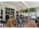 Spacious screened patio features tiled floors, ample seating, and a peaceful outdoor living space at 14423 Tambourine Dr, Orlando, FL 32837