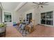 Inviting screened-in porch with ceiling fan, tiled floor, and cozy rocking chairs for outdoor relaxation at 14423 Tambourine Dr, Orlando, FL 32837