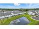 Aerial view of the community featuring a pond, pool, and modern townhome exteriors at 1462 Brookdale Ct, Oviedo, FL 32765
