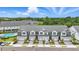 Aerial view of townhomes and a community pool; lush greenery and landscaping at 1462 Brookdale Ct, Oviedo, FL 32765
