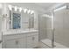 Modern bathroom with dual sinks, quartz countertops, and a spacious glass-enclosed shower at 1462 Brookdale Ct, Oviedo, FL 32765