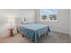 Minimalist bedroom featuring a bed, modern lamp, and natural light creating a peaceful atmosphere at 1462 Brookdale Ct, Oviedo, FL 32765