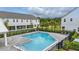 A refreshing community pool surrounded by a sleek black fence and greenery, perfect for relaxation at 1462 Brookdale Ct, Oviedo, FL 32765