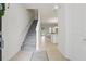 Bright entryway featuring neutral tile flooring, staircase, and an open view to the living spaces at 1462 Brookdale Ct, Oviedo, FL 32765