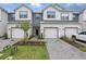 Charming townhomes featuring modern farmhouse design with white siding and well-manicured landscaping at 1462 Brookdale Ct, Oviedo, FL 32765