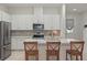 Modern kitchen featuring stainless steel appliances, white cabinets, quartz countertops and island seating at 1462 Brookdale Ct, Oviedo, FL 32765