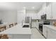 Kitchen with stainless appliances, white cabinetry, quartz counters and island with breakfast bar at 1462 Brookdale Ct, Oviedo, FL 32765