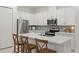 Bright kitchen features white cabinets, stainless steel appliances, and a quartz countertop island at 1462 Brookdale Ct, Oviedo, FL 32765
