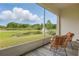 Enclosed lanai with outdoor furniture overlooking a pond and fountain at 1462 Brookdale Ct, Oviedo, FL 32765
