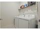 Convenient laundry room featuring a washer and dryer, with shelving for storage at 1462 Brookdale Ct, Oviedo, FL 32765