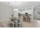 Bright open-concept living room with dining area, showcasing modern lighting and stainless appliances at 1462 Brookdale Ct, Oviedo, FL 32765