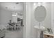 Stylish powder room with a pedestal sink and modern fixtures, next to the dining area at 1462 Brookdale Ct, Oviedo, FL 32765