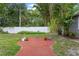 Landscaped backyard features a brick patio, lush greenery, and privacy fence, creating a serene outdoor space at 1519 N Westmoreland Dr, Orlando, FL 32804