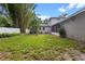 Spacious backyard with screened patio, mature trees, and a well-maintained lawn, perfect for outdoor living at 1519 N Westmoreland Dr, Orlando, FL 32804