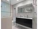 Modern bathroom with double sink vanity, large mirror, and glass-enclosed shower at 1519 N Westmoreland Dr, Orlando, FL 32804