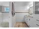 A bathroom featuring a glass door shower, double vanity, marble countertops, and ceramic tile flooring at 1519 N Westmoreland Dr, Orlando, FL 32804
